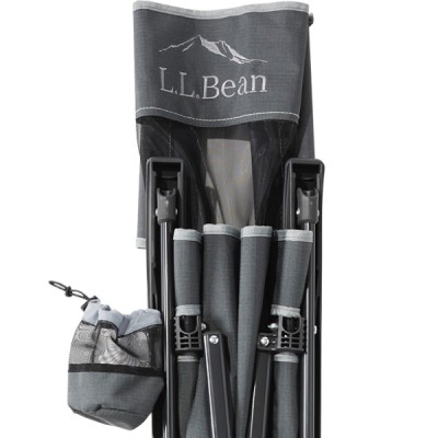 Folded green camping chair with a cup holder and the brand name L L Bean visible on the backrest.
