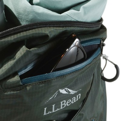 A L L Bean backpack pocket with a pair of sunglasses partially visible inside. 