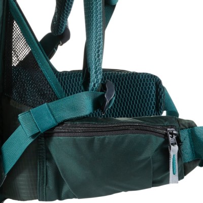 Close-up of a green backpack with a zippered pocket and padded straps. 
