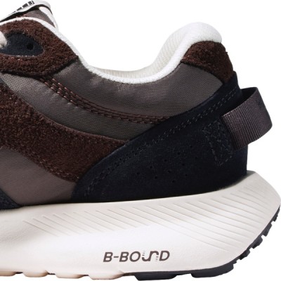 Interior side view of the back half of a black and white sneaker.