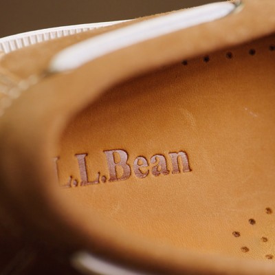 Close-up of embossed L.L.Bean logo inside a tan leather shoe.