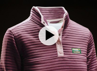 Plum-colored ribbed pullover with a snap-button collar and L L Bean logo, shown on a mannequin against black background with play video icon.