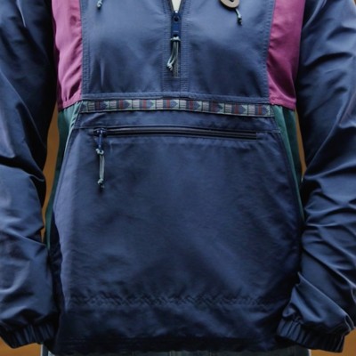 Front view of color-blocked L L Bean anorak showing kangaroo pocket, zipper, and patterned trim accent.