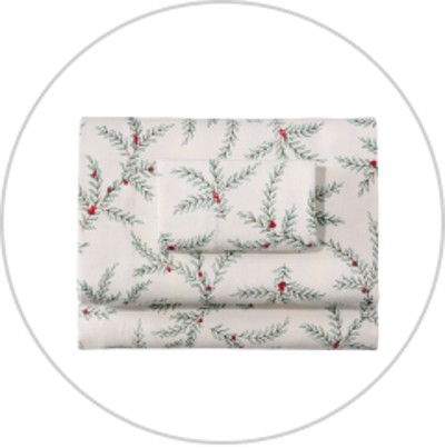 A folded set of elegant holiday themed flannel sheets.