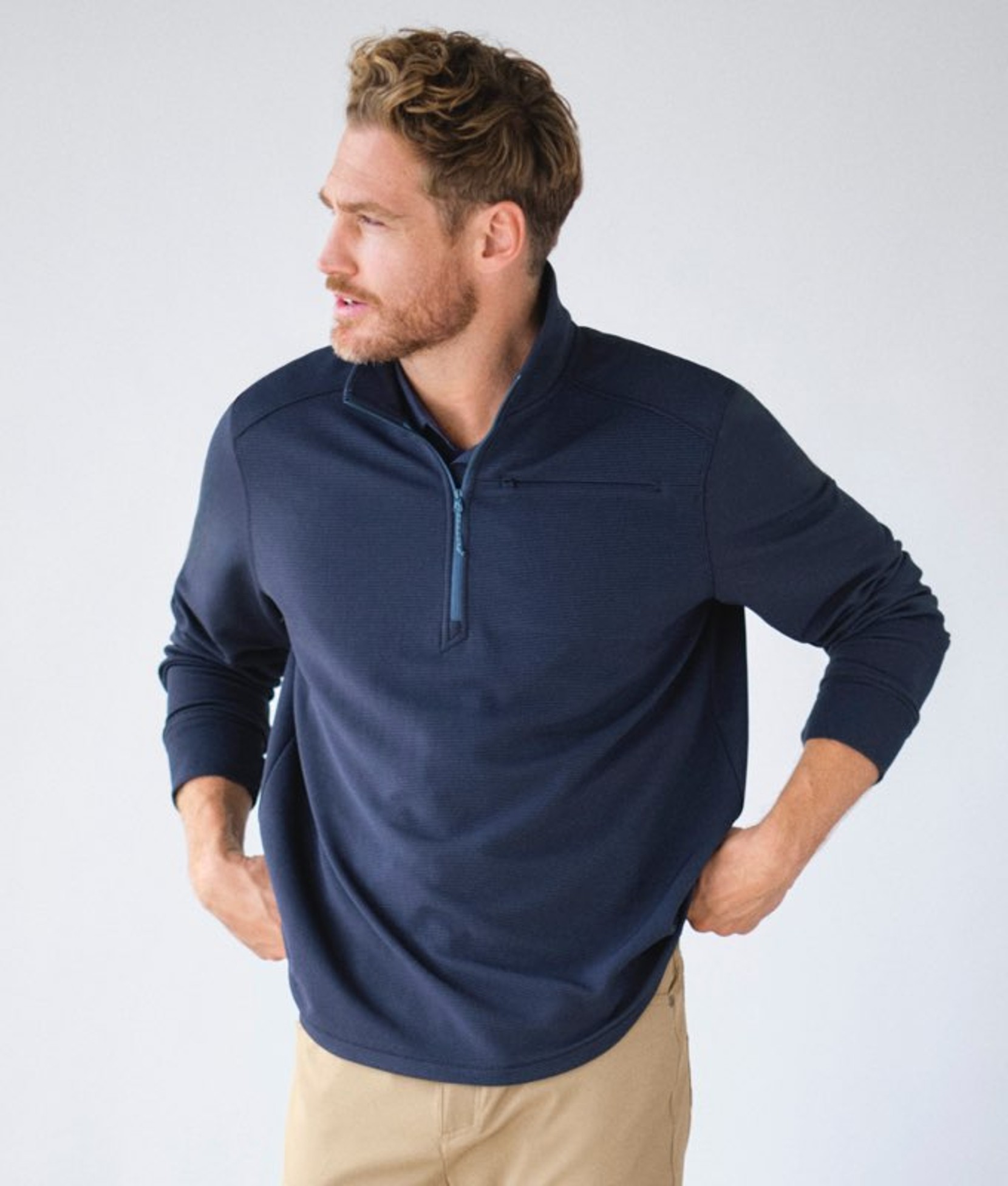 Navy men’s quarter‑zip activewear top worn by a model. 