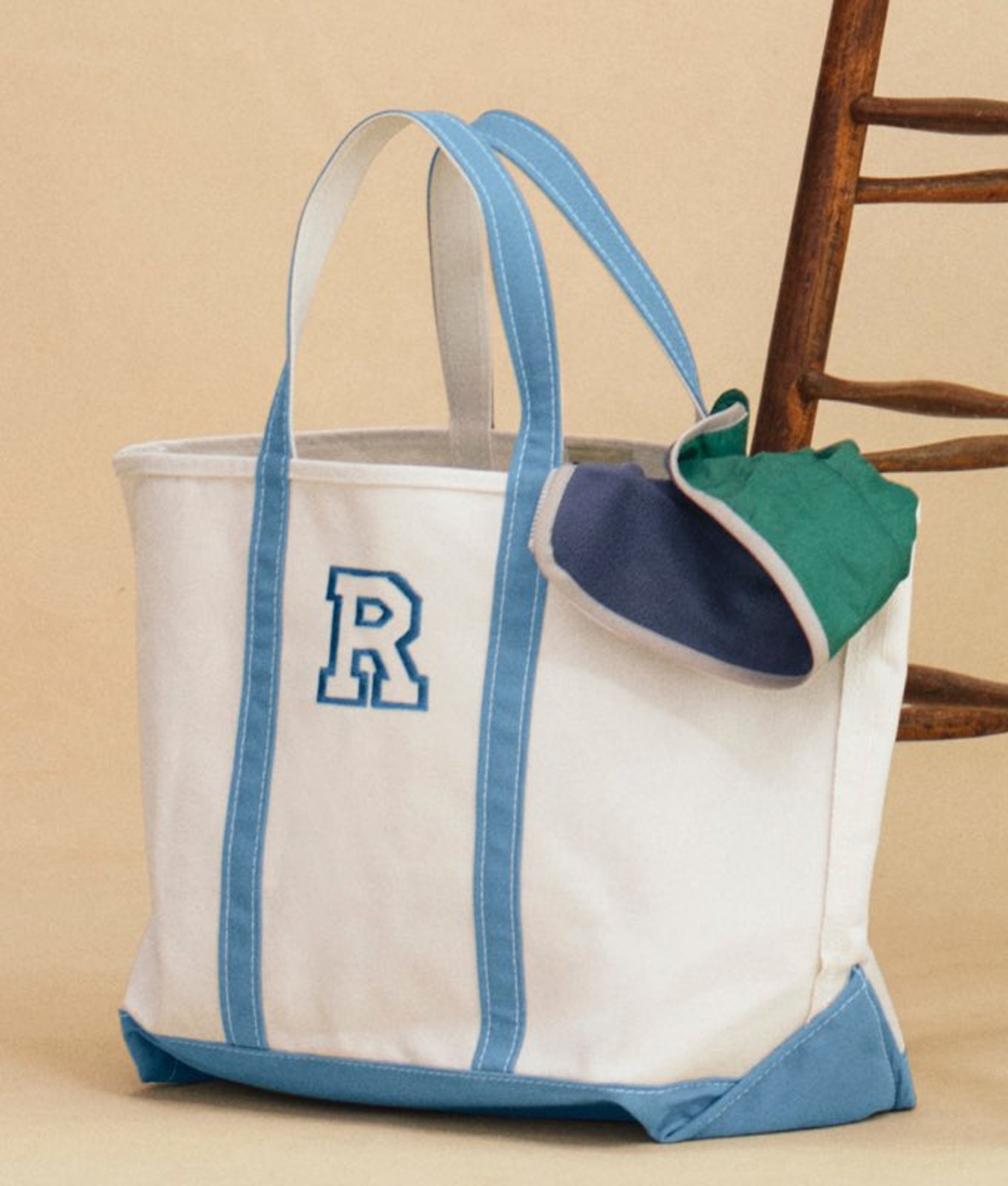 Canvas tote bag with blue trim and handles. 