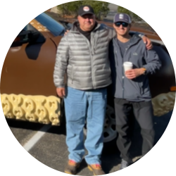 Bob standing in front of the Bootmobile and wearing a baseball hat.