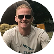 A portrait of Kevin P. smiling and wearing sunglasses.