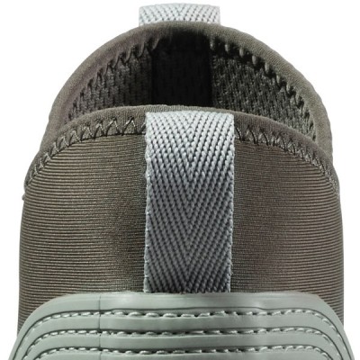 Close up of pull loop on a rugged boot with textured rubber and soft interior lining.