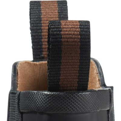 Close up of striped pull loops on a rugged boot with textured rubber and soft interior lining.