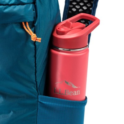 Close up image of blue Stowaway Pack side pocket holding a red L. L. Bean water bottle.
