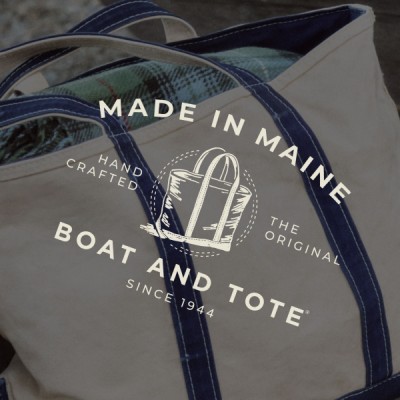 Close-up of a Made in Maine Boat and Tote canvas bag with blue straps and printed tote graphic logo.