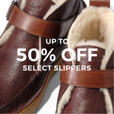 Cropped image of shearling lined slippers with text "up to 50% off select slippers".