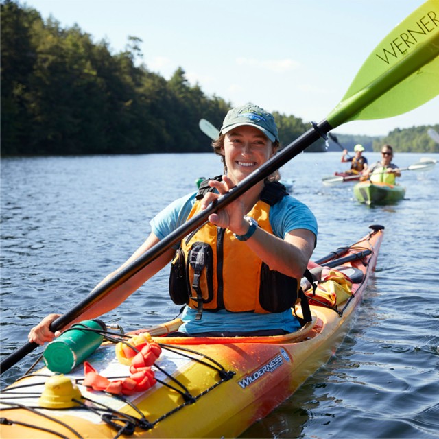 3 people paddling in kayaks.