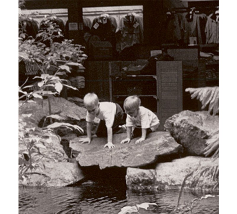 Boys look into the trout pond at the Freeport L.L.Bean store.