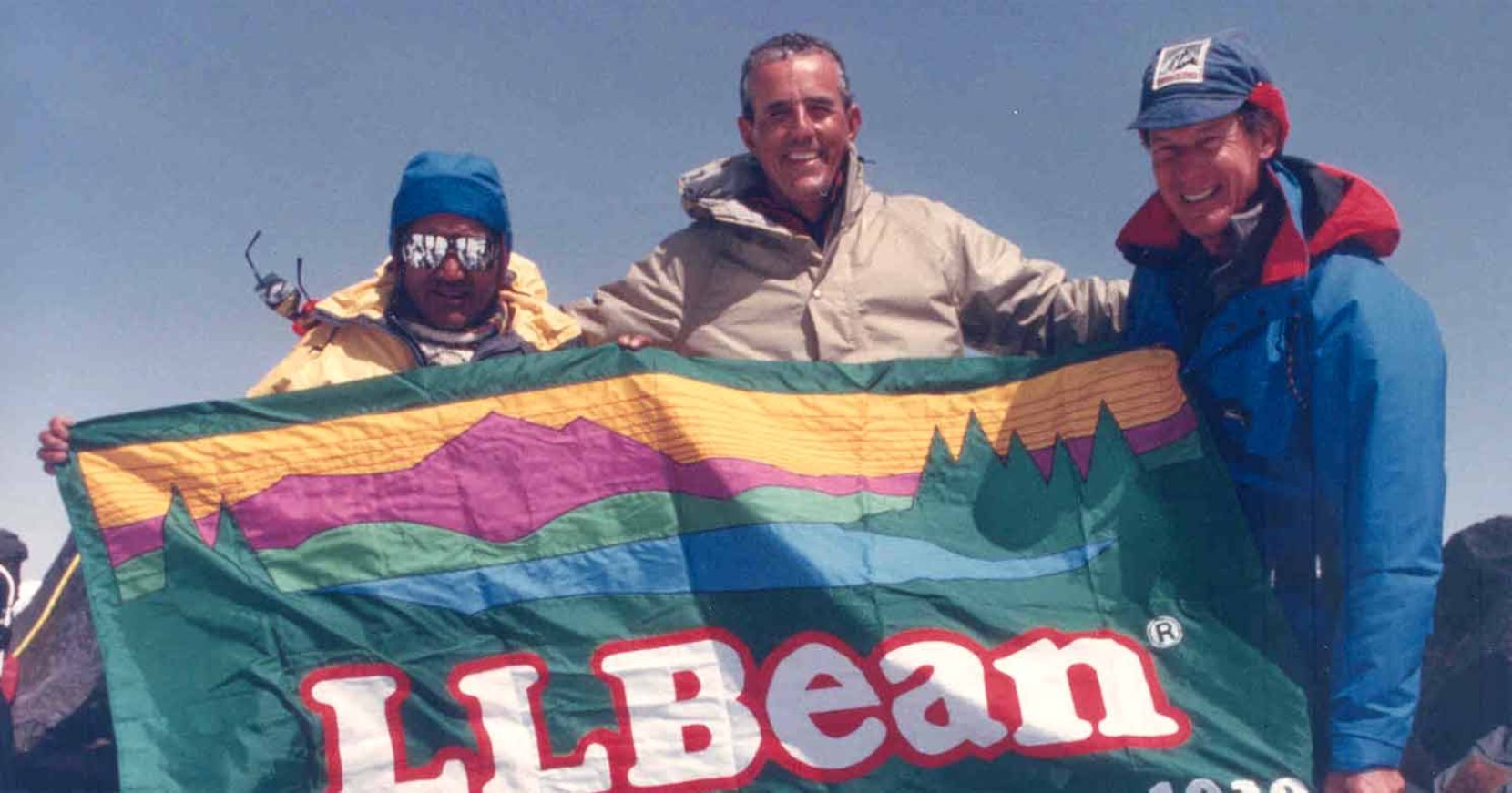 Leon Gorman and his fellow mountain climbers, holding an L.L.Bean flag.