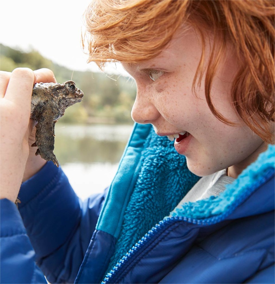 Image of boy in L.L.Bean Clothes looking into eyes of Frog