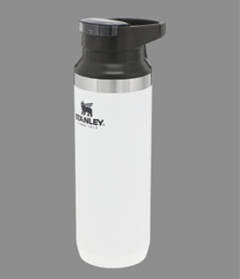 A white Stanley 1913 Trigger Action Travel Mug on a gray background