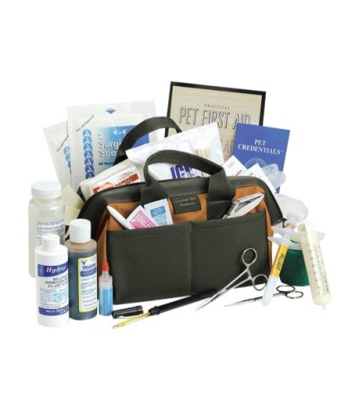 Sport Dog First Aid Kit open with contents on the table or peeking out of the handled container.